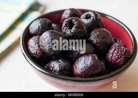 Dried Black Olive Chips / Crackers without seeds in Bowl. Organic Appetizer. Stock Photo