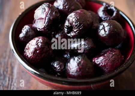 Dried Black Olive Chips / Crackers without seeds in Bowl. Organic Appetizer. Stock Photo