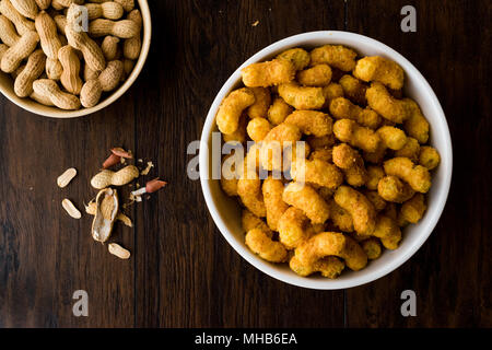 Peanut Chips on dark wooden surface. Fastfood. Stock Photo