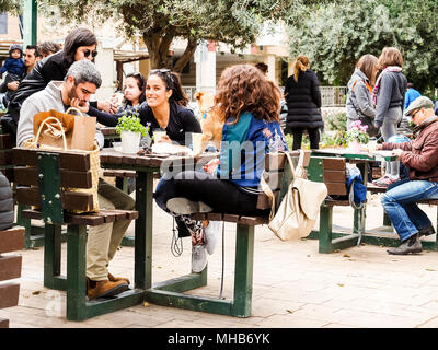 Israel, Tel Aviv.  Merry company of friends drinking morning coffee on Ben Gurion Boulevard. Stock Photo