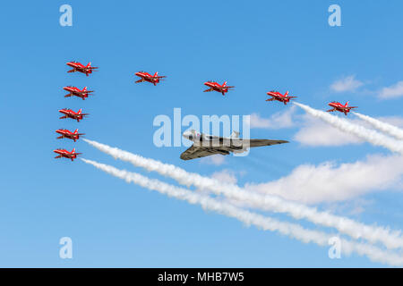 The full 9 Red Arrows in formation with the Vulcan XH558 in this rare picture not seen very often nor will be seen ever again, Stock Photo