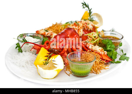 Lobster served with the vegetables on a white plate. Isolated Stock Photo