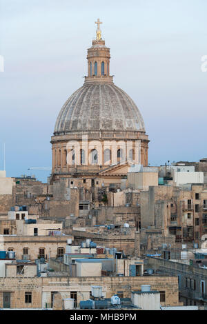 A view down Old Mint Street of The Basilica of Our Lady of Mount Carmel  a Roman Catholic church in the Maltese capital Valletta, Malta Stock Photo