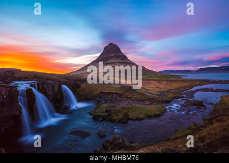 Kirkjufell Church mountain at sunset with pink and orange skyline, Iceland Stock Photo