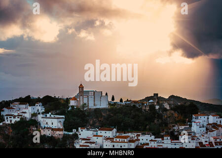 White Andalusian village - pueblo blanco - in the mountain range in Casares during sunset Stock Photo