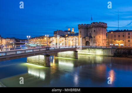 View of the town, bridge over the Meuse with gate Porte Chaussée, dusk, Verdun, Grand Est, France Stock Photo