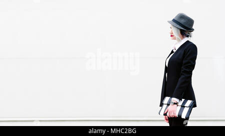 Fashionable businesswoman standing on white background Stock Photo