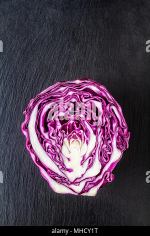 Purple cabbage.cut in half on a slate board Stock Photo