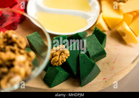 Pieces of cheese of different varieties with honey Stock Photo