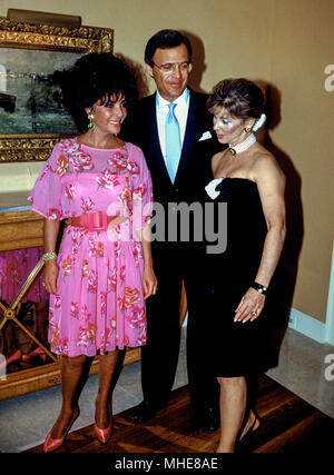 Washington, DC USA, 2nd June, 1987 Elizabeth Taylor poses with Stuart and WIlma Bernstein who served as hosts for an AMFAR fundraiser in their penthouse condo at Washngton Harbour. Credit:Mark Reinstein /MediaPunch Stock Photo