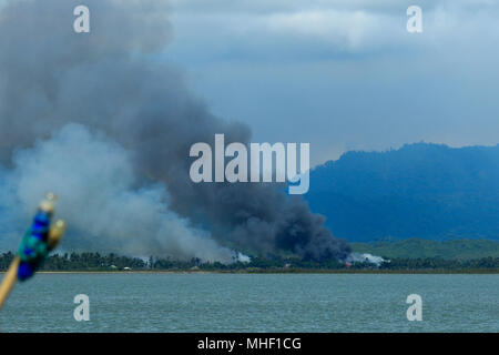 Smoke is seen on the villages in Maungdaw area in Myanmar border set on fire allegedly by the Myanmar Army and other forces. Teknaf, Cox's Bazar, Bang Stock Photo