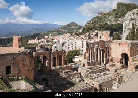 Ancient Greek-Roman theatre of Taormina with town and Mount Etna, Sicily. Stock Photo