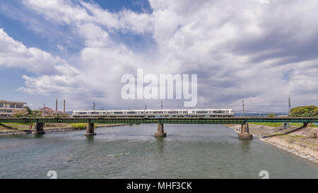 Beautiful view of the railway bridge on the river Uji with the train running through it, Kyoto district, Japan Stock Photo