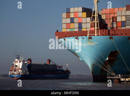 Maersk Container Ship, zoomed in on bow. Tied up in port. Another boat going past Stock Photo