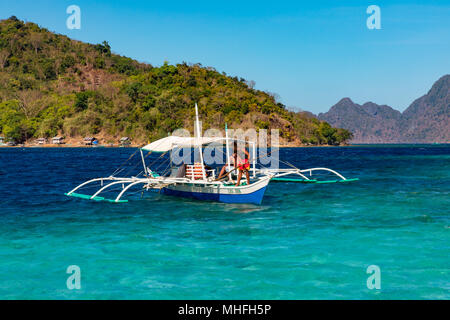 Coron Palawan Philippines April 13, 2018 Traditional outrigger tourist boats at CYC beach Stock Photo