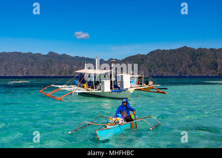 Coron Palawan Philippines April 13, 2018 Traditional outrigger tourist boats at CYC beach Stock Photo