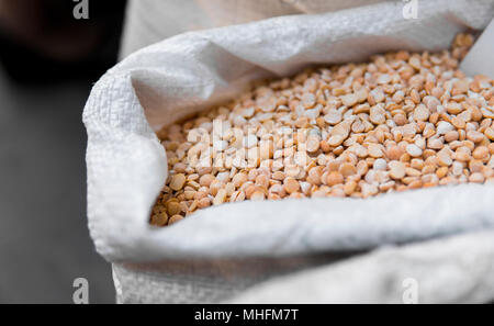 Close up on a dry raw chickpeas in a box. Macro. Healthy dietary food rich in microelements cellulose. Food for vegeterian and people who cares about  Stock Photo