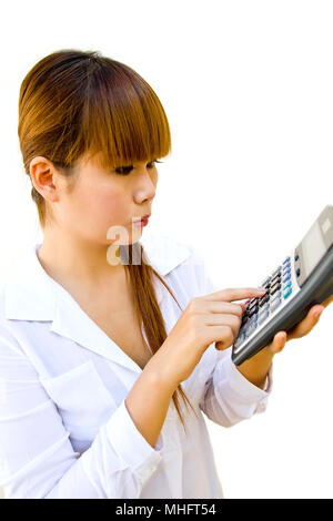 Thinking woman using calculator to make calculations Stock Photo