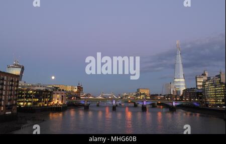 View from Millennium Bridge toward Southwark Bridge and Shard under full moon, Stock Photo