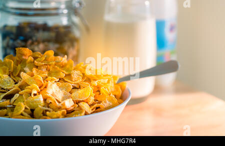https://l450v.alamy.com/450v/mhg7r4/bowl-of-cereal-with-spoon-put-on-wood-table-near-granola-in-glass-container-and-one-glass-of-milk-calcium-food-breakfast-for-children-before-go-to-sc-mhg7r4.jpg