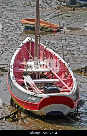 The coble ‘Whitby’ sits grounded at her moorings on a bed of muddy sand at low tide in Scarborough harbour. Stock Photo