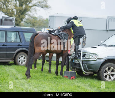 person mounting a horse Stock Photo