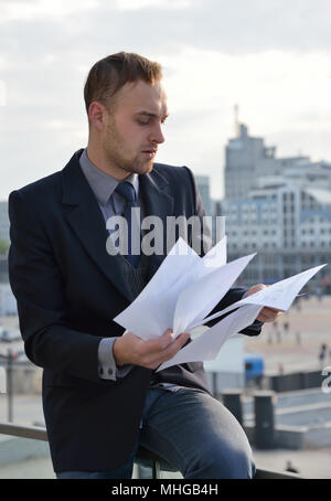 businessman emotionally reading documents Stock Photo