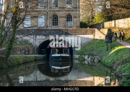 A narrow canal boat passing through Sydney Gardens Tunnel under  Cleveland House, Kennet and Avon Canal, Bath, Somerset, UK Stock Photo
