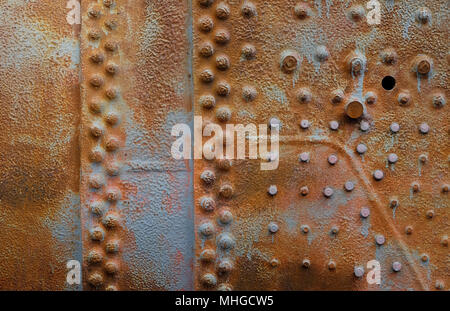 weathered sheet metal with rivets background Stock Photo