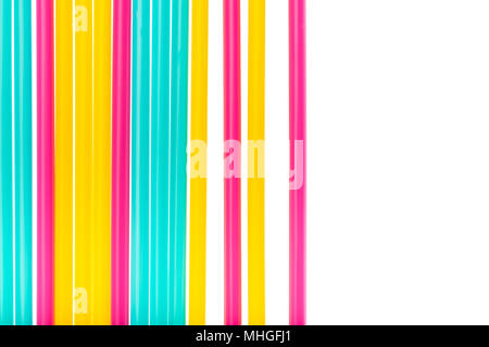 Colorful fluorescent drinking straws against white background with copy space Stock Photo