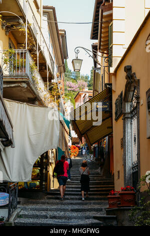 Tourists walk up stairs in the old town of Bellagio, Italy Stock Photo