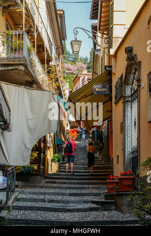 Tourists walk up stairs in the old town of Bellagio, Italy Stock Photo