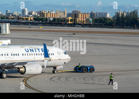 Towing a United Airlines jet on the taxiway at Miami International Airport in Miami, Florida. Stock Photo