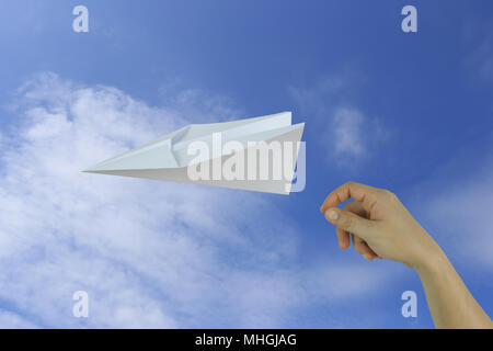 Hands of businessman throwing a paper plane on blue sky background and have copy space for design in business concept. Stock Photo