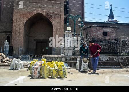 Laborers work at a construction site on the eve of International Labor Day in Srinagar, Indian administered Kashmir. International Labor Day also known as May Day is marked across the world on May 1.The International Labor Day commemorates the historic struggle of working people throughout the world. Stock Photo