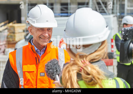 Cazis, Switzerland, 1st May 2018. Markus Dünner, Head of the building authorities of the canton of Grisons is interviewed during the media event on the topping out of the new penal institution Realta in Cazis. Credit: Rolf Simeon/Alamy Live News Stock Photo