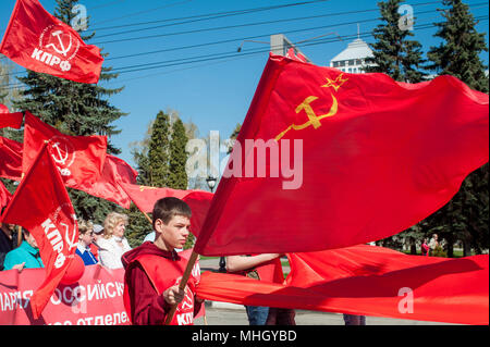 Tambov, Tambov region, Russia. 1st May, 2018. The March of the members of the Tambov branch of the Communist party of the Russian Federation, in honor of the Holiday of spring and labor (May 1, 2018, the city of Tambov, Russia). In the photo - rally Tambov Communists. A young man with a red banner with the symbol of the USSR-hammer and sickle. Credit: Aleksei Sukhorukov/ZUMA Wire/Alamy Live News Stock Photo