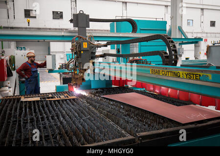 26 April 2018, Germany, Hamburg: Ramazan Solmaz, welder and machine operator, working with the autogenous plasma cutting device 'Kadett' in the modernised and renovated shipbuilding hall 2 in the shipyard facilities of Blohm Voss. Hamburg's traditional shipyard is set on a new course nearly a year and a half after the acquisition of Blohm Voss by Bremen's Luerssen Group. Photo: Christian Charisius/dpa Stock Photo