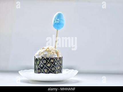 Easter egg and cupcake on white background Stock Photo