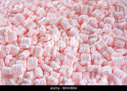 S-shaped pink packing peanuts as a background Stock Photo