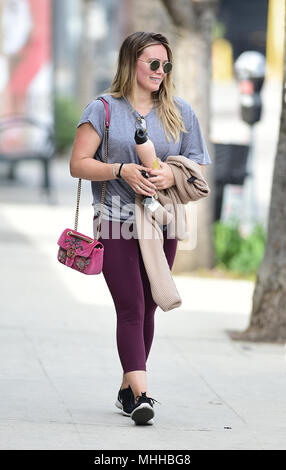 Hilary Duff carries a pink Gucci bag after a hard workout on her first