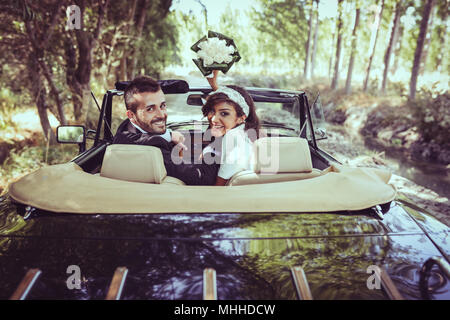 Just married couple together in an old car Stock Photo