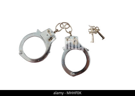 Arrest or bontage concept. Metal locked handcuffs and the keys isolated on white background, top view Stock Photo