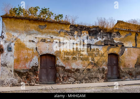 Antigua, Guatemala - April 5, 2009: Rundown old building in UNESCO World Heritage Site. Translates to Property of the National Hospital of Antigua. Stock Photo
