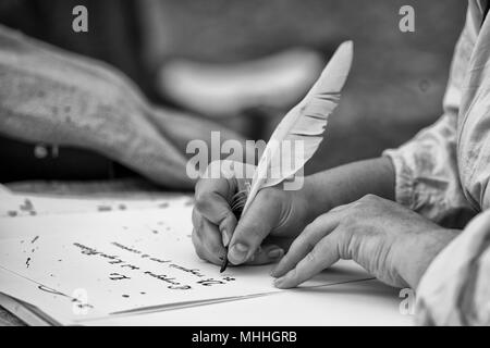 hands while writing a letter with a plume in black and white Stock Photo