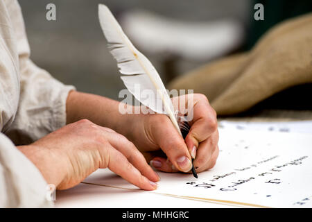 hands while writing a letter with a plume Stock Photo