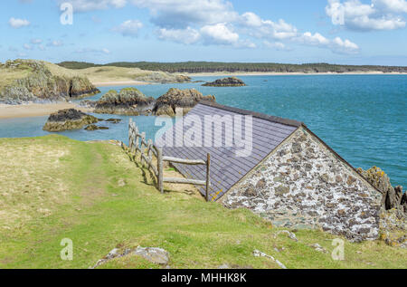 A view from the boat house at Llanddwyn Island on Anglesey with Newborough forest in the distance. Stock Photo