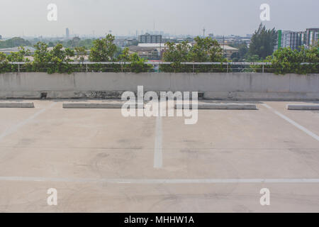 Empty space of car parking lot on rooftop floor of buildings. Stock Photo