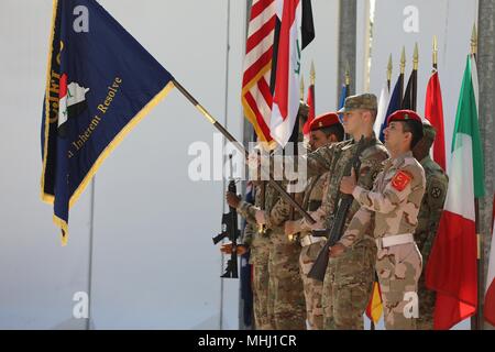 Coalition members with the Combined Joint Forces Land Component Command color guard render a salute during the CJFLCC deactivation ceremony at Baghdad, Iraq, April 30, 2018, April 30, 2018. The deactivation signifies the end of major combat operations against ISIS in Iraq and acknowledges the changing composition and responsibilities of the Coalition. (U.S. Army photo by Sgt. Jonathan Pietrantoni). () Stock Photo