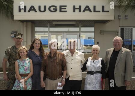 'We are very honored to know that he is not forgotten, and to know the Marines remember him, ' said Joe Braunschweig, center, nephew of Medal of Honor recipient Cpl. Louis J. Hauge, Jr. Combat Logistics Regiment 35, 3rd Marine Logistics Group, dedicated their headquarters building in memory of Hauge for his heroic actions during the Battle of Okinawa, April 30, 2018 on Camp Kinser, Okinawa, Japan, April 30, 2018. Braunschweig is a native of Browns point, Washington. (U.S. Marine Corps photo by Lance Cpl. Jamin M. Powell). () Stock Photo